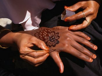 Henna tattoos being applied